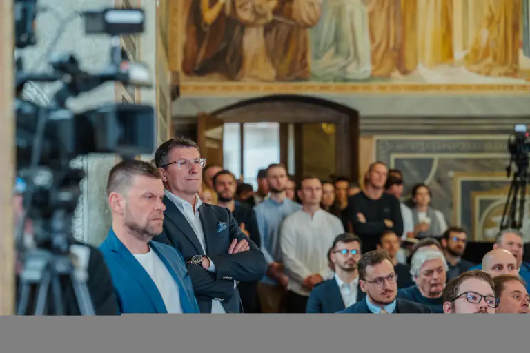 Conference audience listening beside the production camera