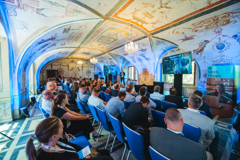 Presentation screen and audience seating in a historic event venue