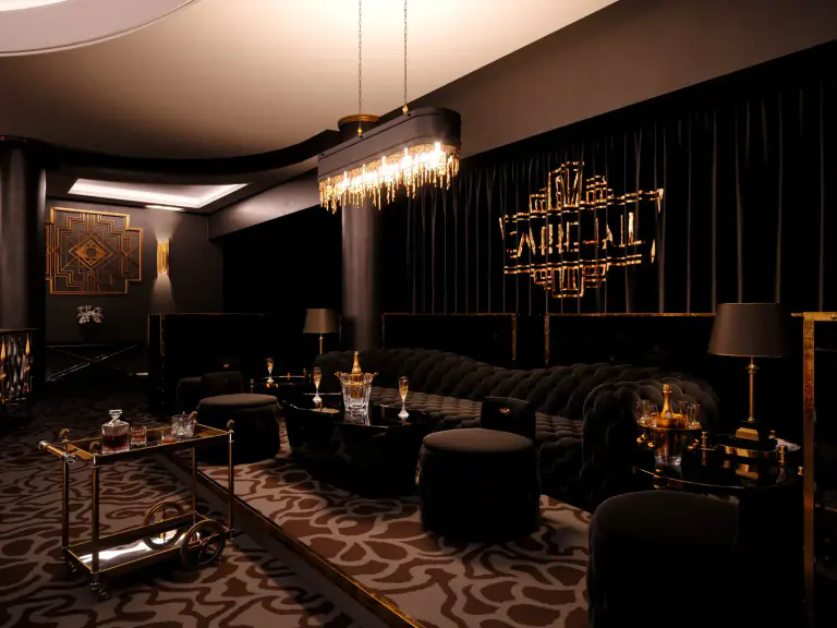 Dark lounge with a bar cart and Empire Hall branding at Slovanský dům