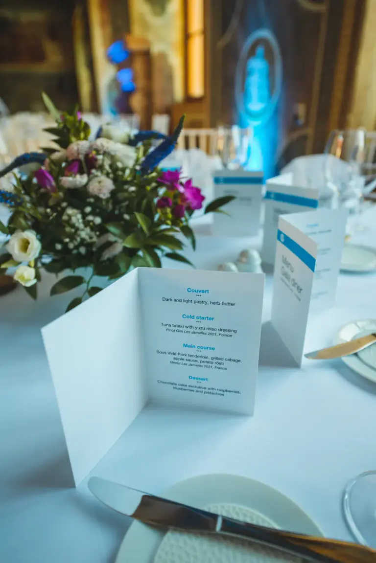 Printed menu and floral place detail for a gala dinner