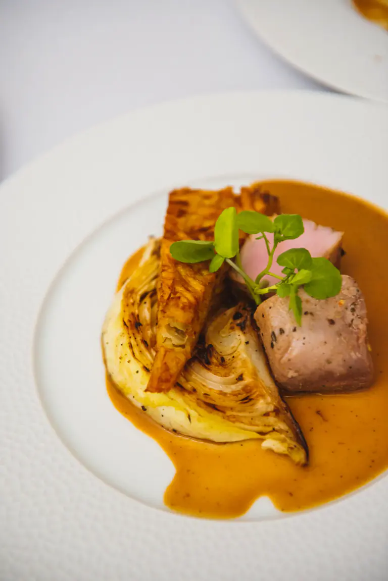 Elegant plated main course with seasonal garnish