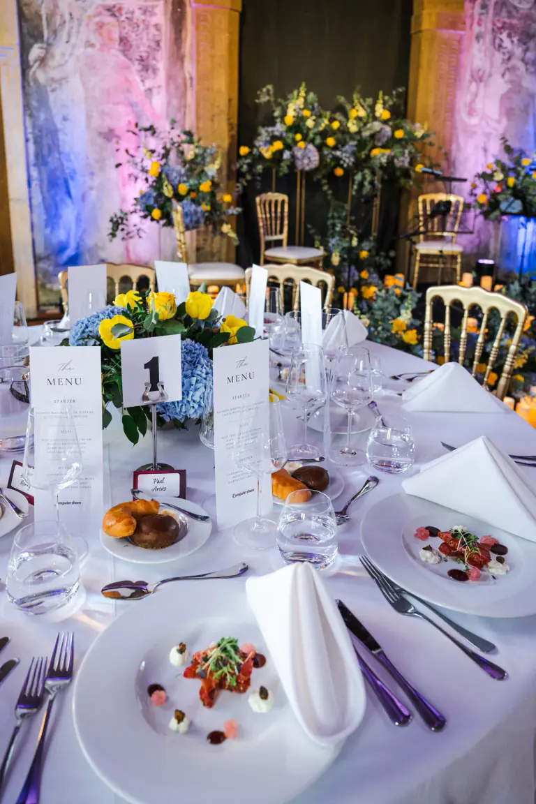 Portrait table arrangement with candles, florals and place settings