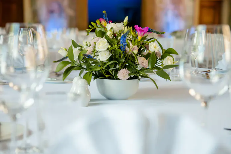 Contemporary floral centrepiece among crystal glassware