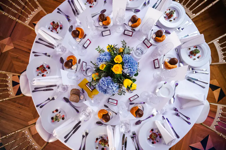 Round gala table viewed from above with complete place settings