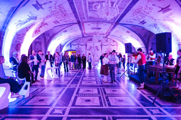 Guests gathering beneath the illuminated vaults of Martinic Palace
