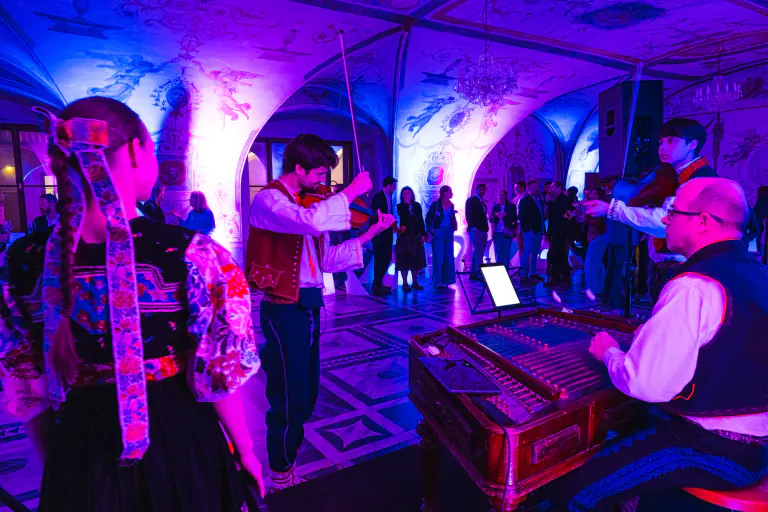 Guests watching an energetic cultural performance at a gala event