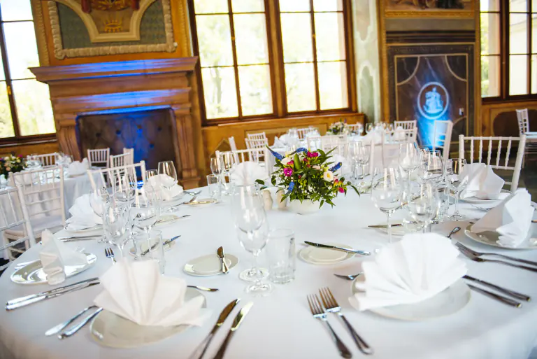 White linen dinner table prepared in a historic palace room