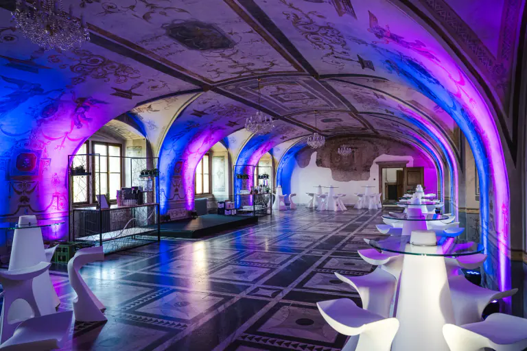 Blue-lit columns and ceiling details in a ceremonial Prague venue