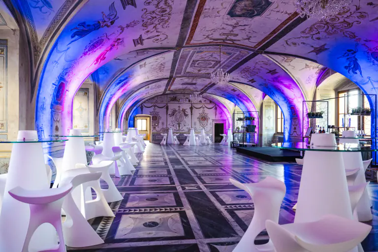 Blue and magenta architectural lighting across a heritage interior