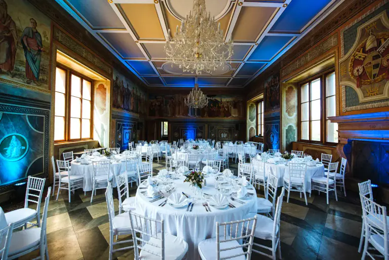 Martinic Palace dinner room with blue architectural lighting and round tables