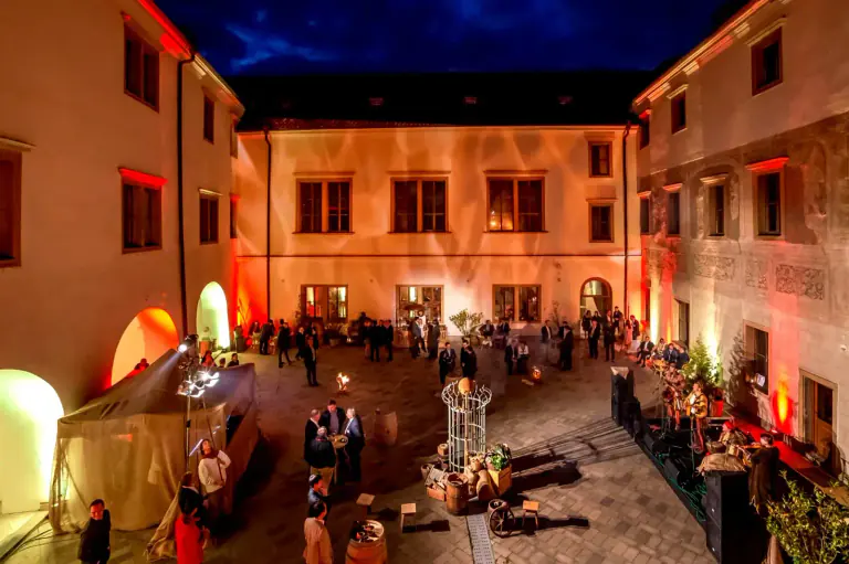 Evening reception in an illuminated historic Prague courtyard