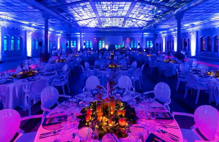 Blue and magenta gala lighting across the Gabriel Loci hall