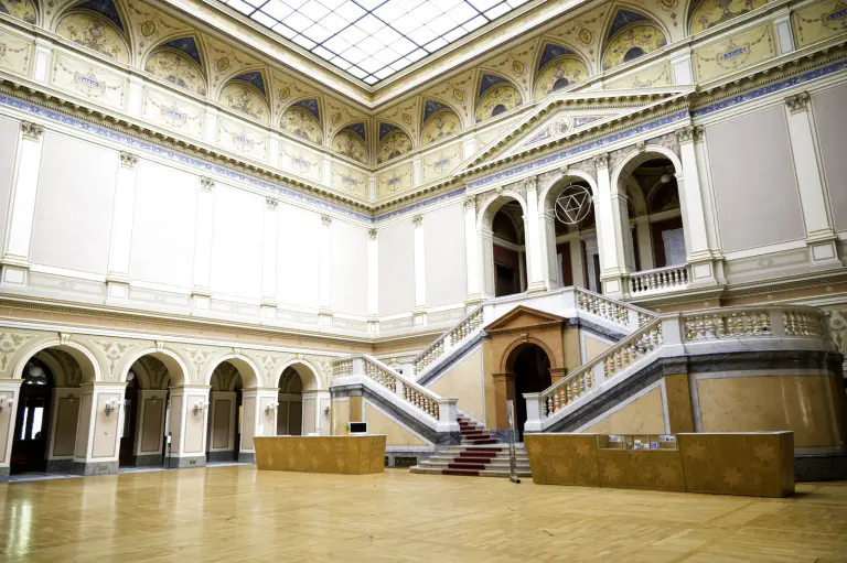 Rudolfinum foyer with a grand staircase beneath a glass roof