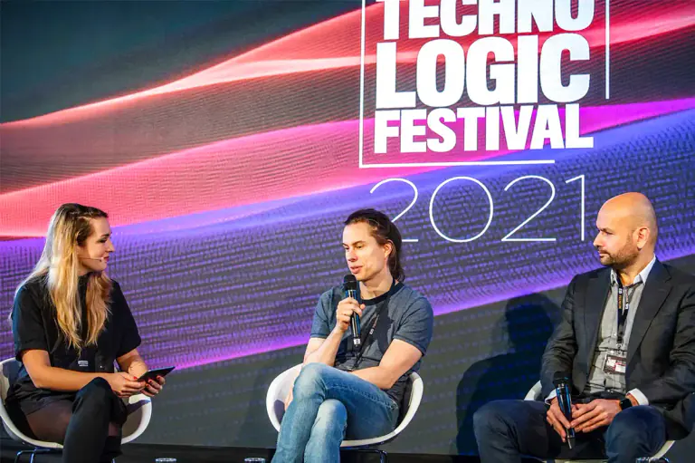 E-commerce and technology festival panel discussion on a lit stage