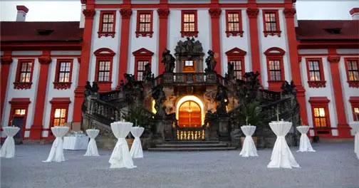 Troja Château courtyard prepared for an outdoor reception with cocktail tables