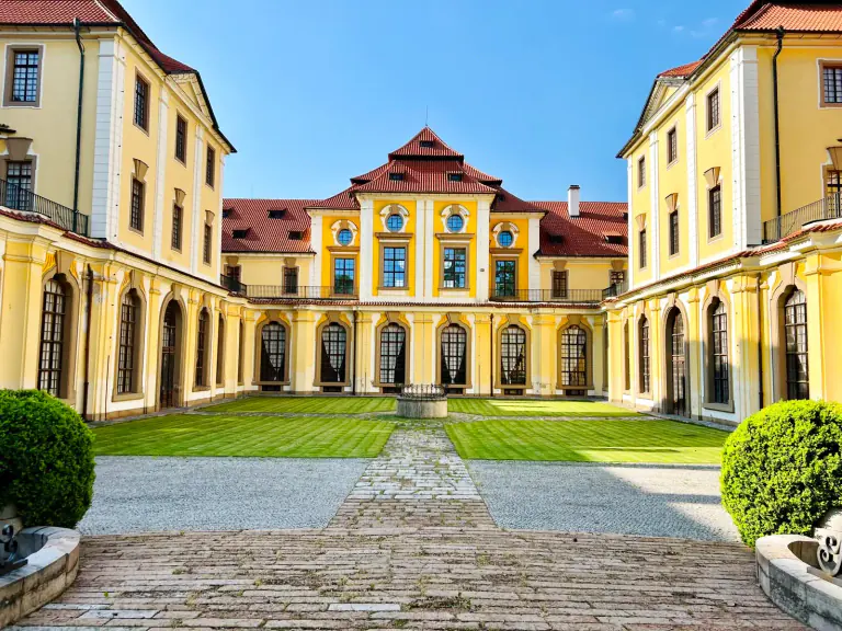 Zbraslav Château courtyard framed by Baroque wings and a manicured lawn