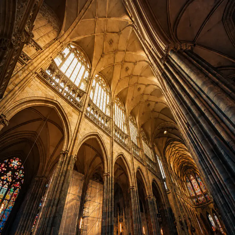 Stone vaults and stained glass inside St. Vitus Cathedral