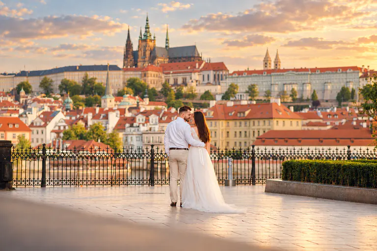 Wedding couple overlooking Prague Castle at sunset