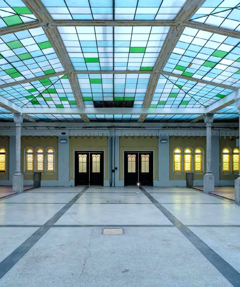 Stained-glass roof and empty reception floor at Gabriel Loci
