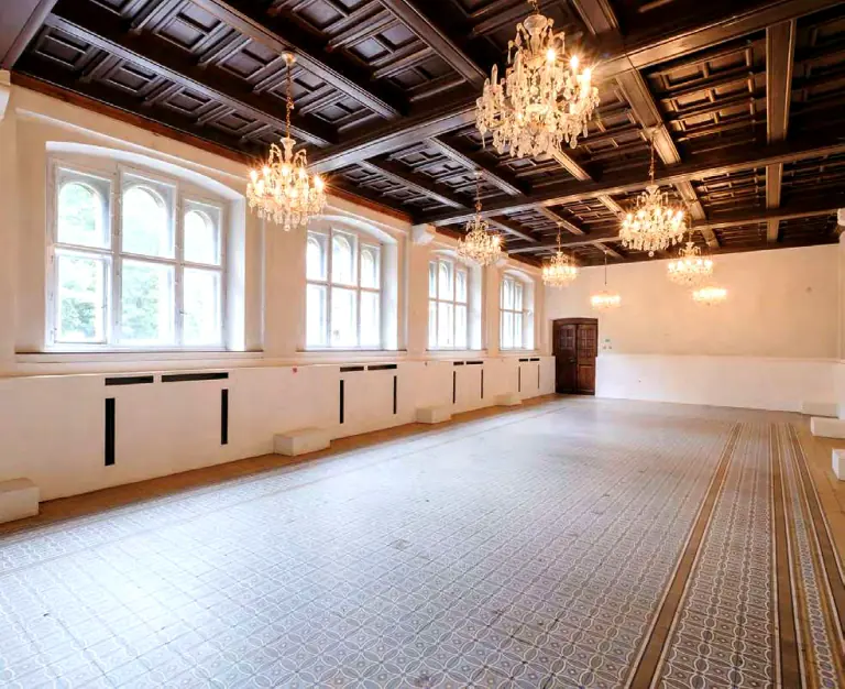 Historic Gabriel Loci room with a dark coffered ceiling and crystal chandeliers