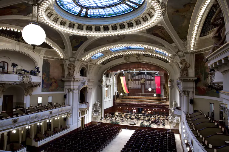 Municipal House concert hall with stained glass, balconies and an orchestra stage