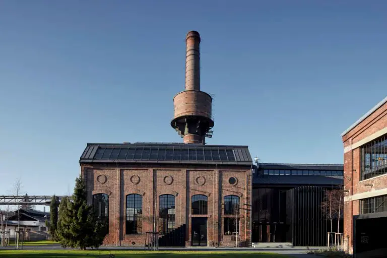 Exterior of the restored Uhelný mlýn industrial building with its chimney
