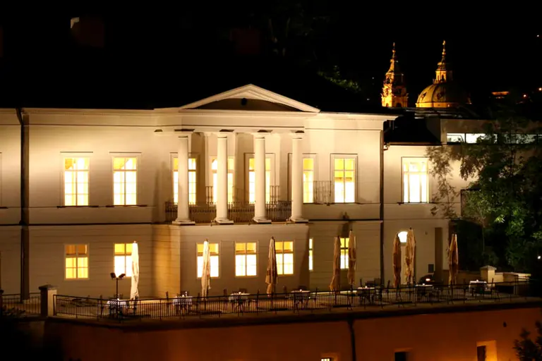 Villa Richter illuminated at night above the Prague Castle vineyard